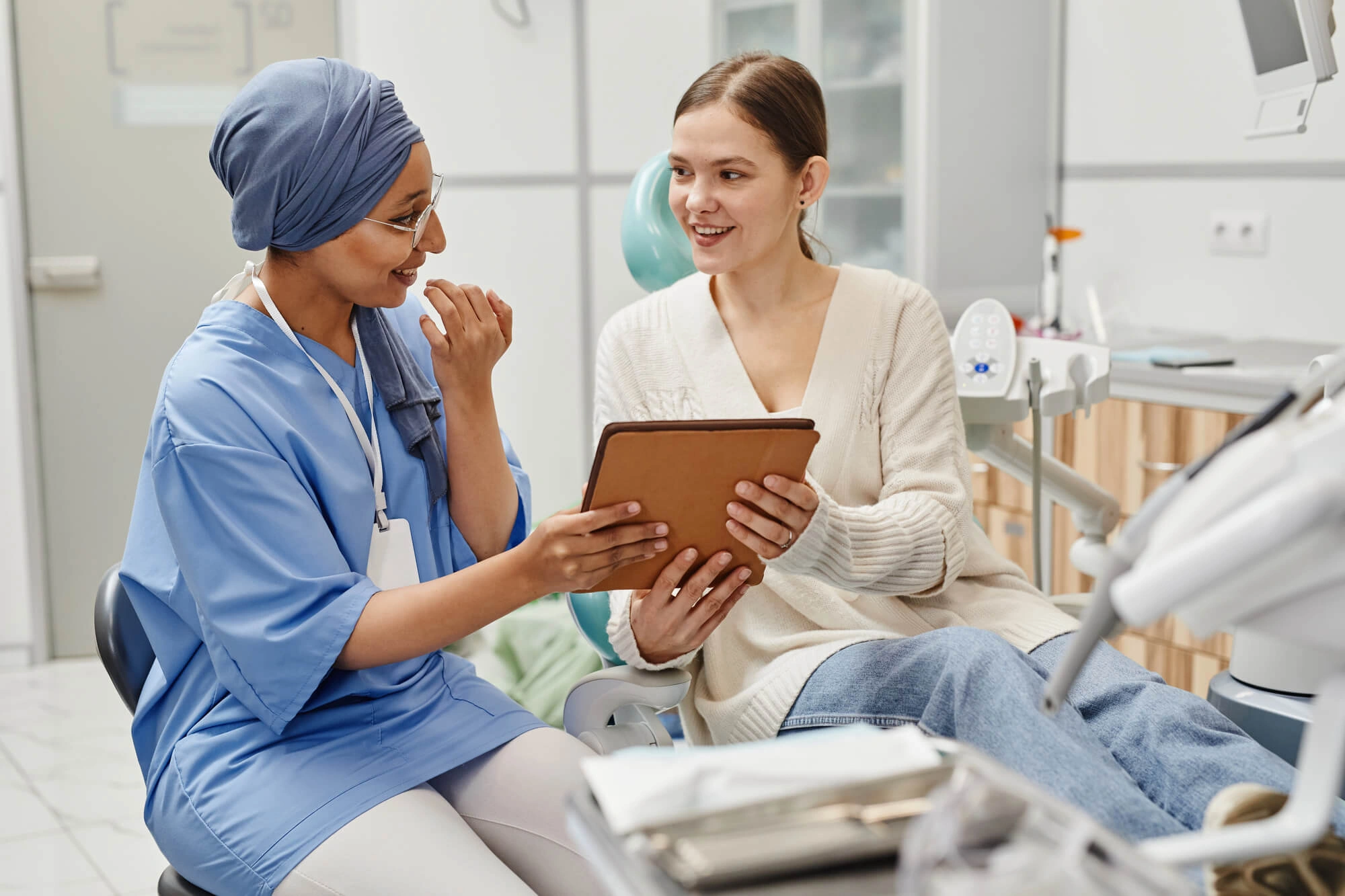Girl and dentist talking about laser gum surgery palm beach gardens